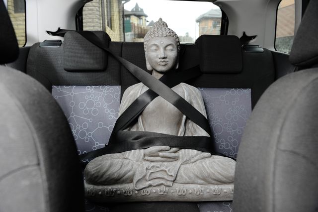Buddha strapped in to car